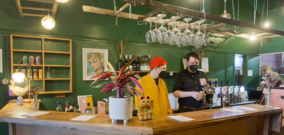 Sam Valentine (left) watches as his new business partner Troy Butler pours a pint at Morning...