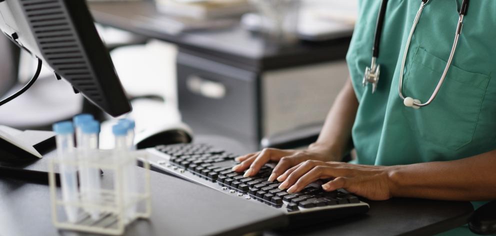 A nurse or doctor on a hospital computer. Photo: Getty Images