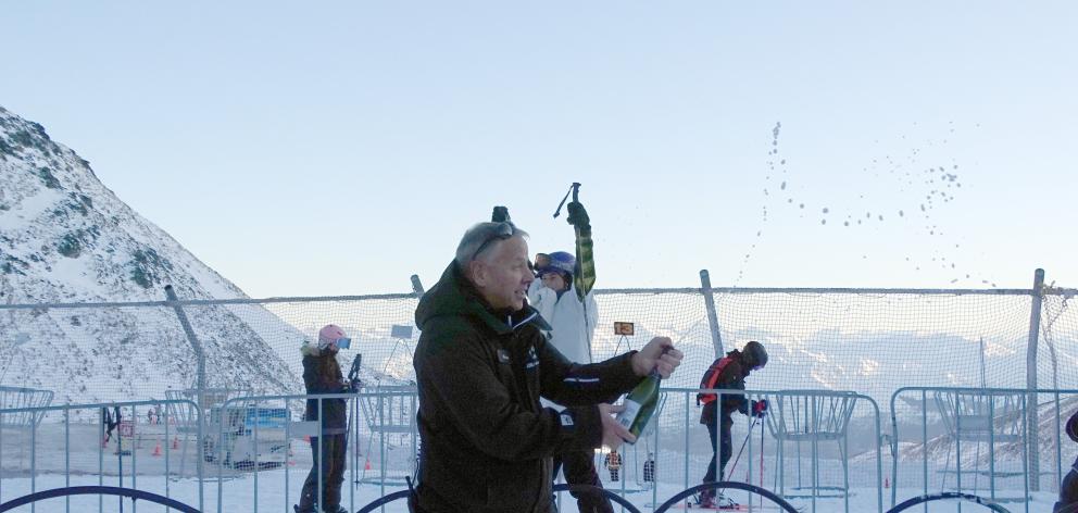Remarkable ski area manager Ross Lawrence pops the opening day bubbles .PHOTO: CASS MARRETT