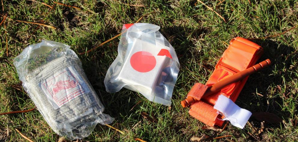 Three first aid items Alex McDonald keeps in his backpack are (from left) gauze, pressure...