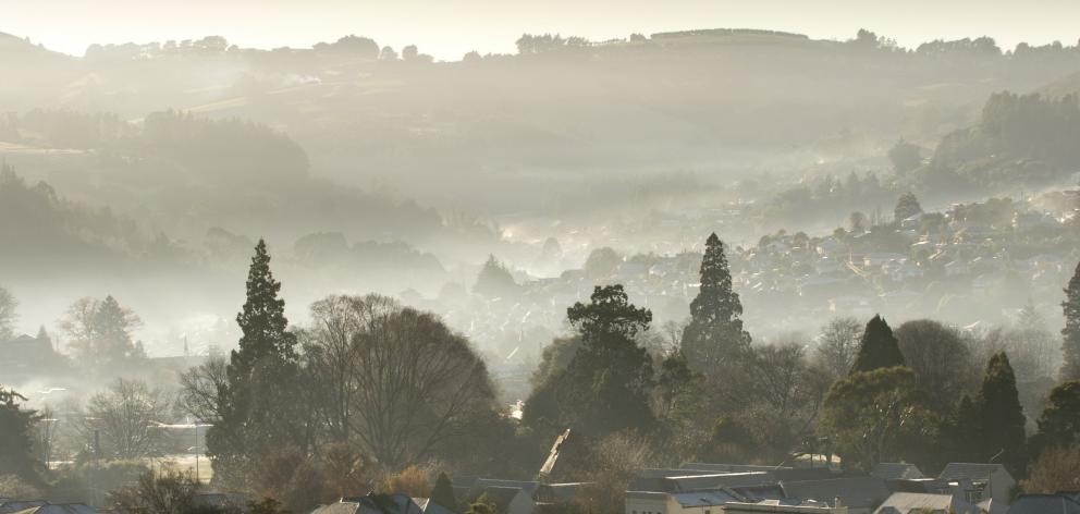 North East Valley, in Dunedin, is blanketed in smoke after a cold start to the day yesterday....