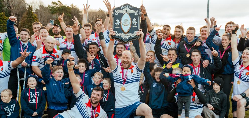 Woodlands captain Marty McKenzie hoists the Galbraith Shield after victory over Pirates Old Boys...