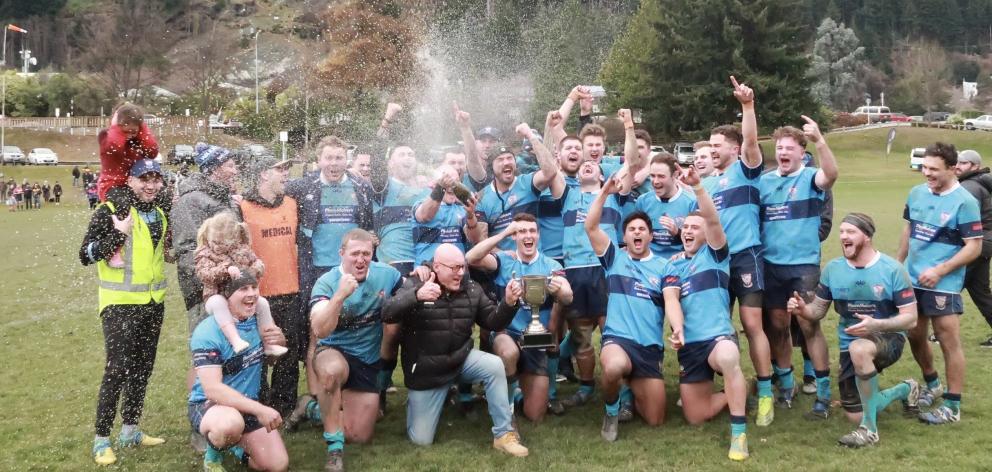 Wakatipu rugby players are joined by Mayor Jim Boult as they celebrate their victory in the...
