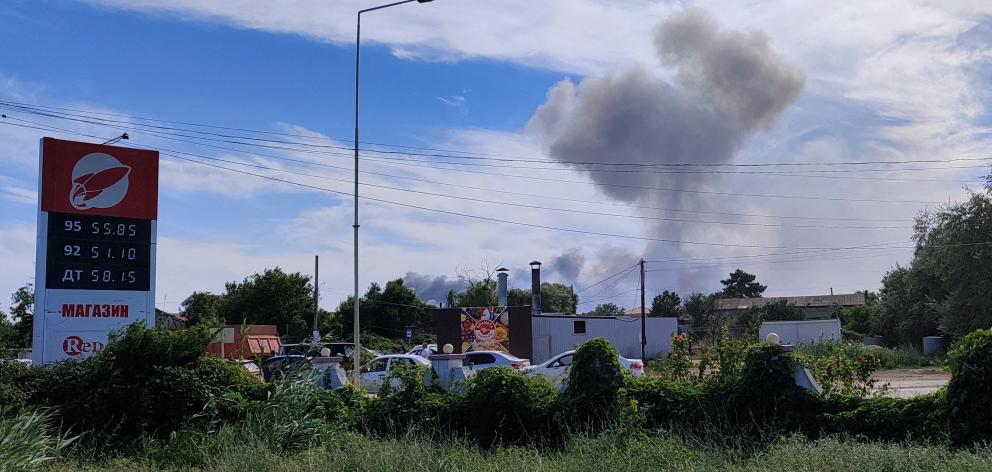 Smoke rises after explosions were heard from the direction of a Russian military airbase near...