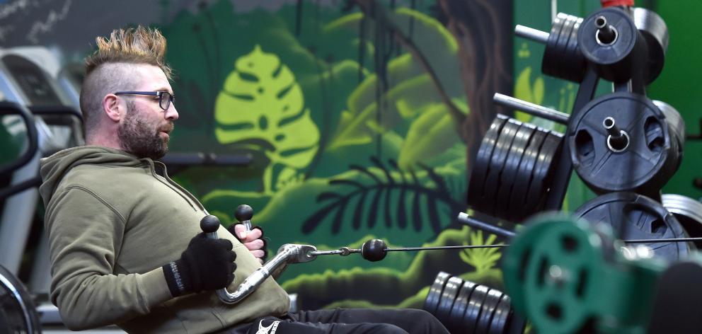 Personal trainer Dave Parker works out at Propel Fitness, where he gives others with multiple...