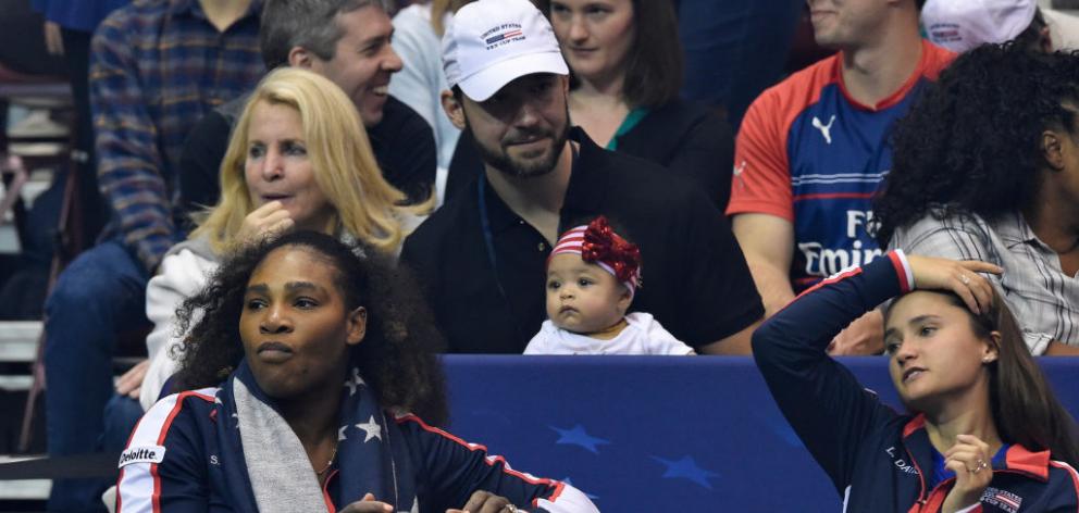 Serena Williams (left) with husband Alexis Ohanian and their daughter Alexis Olympia (centre) in...