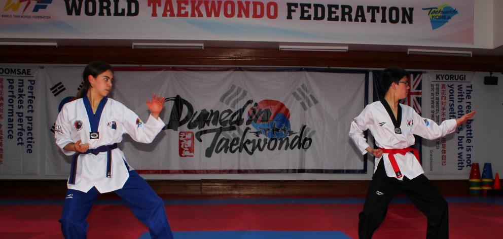Dunedin Taekwondo Associated pupils Sophia Le (17, left) and Ryan Zhou (14) practise poomsae, or...