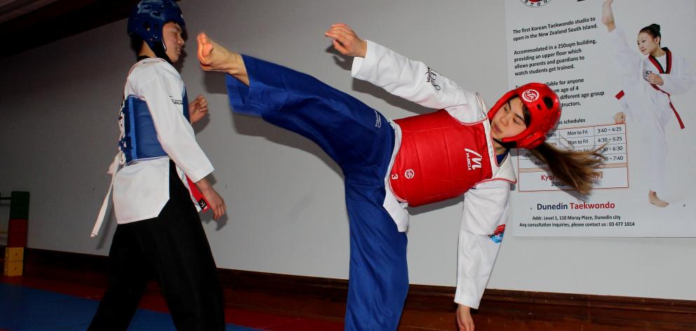 Ryan (left) and Sophia practise kyorugi, or sparring. PHOTO: SIMON HENDERSON
