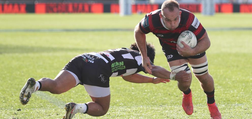 Tom Christie from Canterbury wrong foots Stacey Ili from Hawkes Bay to cut inside and score the...