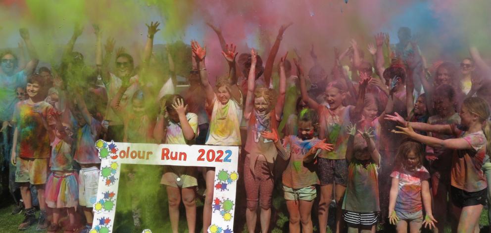 Participants in the Cromwell College 2022 Colour Run celebrate at the end of the event on...