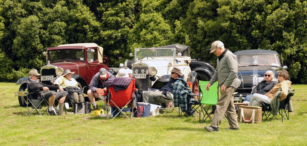 Participants in the Vintage car club 50th Taieri Tour have some lunch next to their cars in Outram.