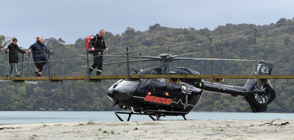 A tramper (centre) with an injured knee was airlifted from Maori Beach on Stewart Island on...