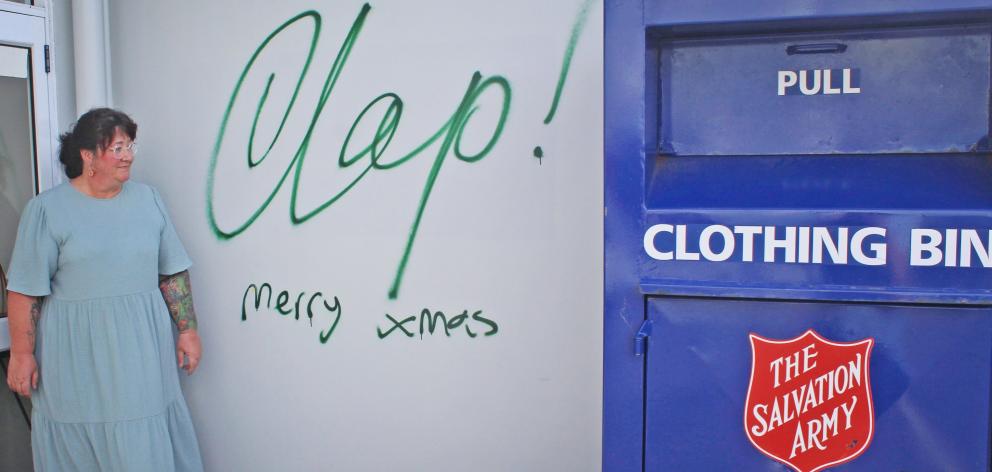 Salvation Army Family Store manager Tania Johnston stands next to a rudimentary "clap" tag on the...