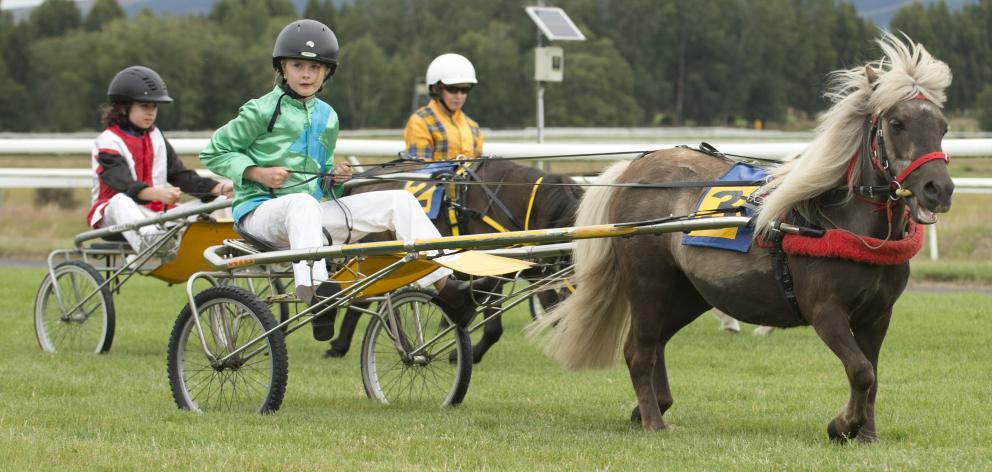 Cart racers (from left) Gabrielle Campbell, Sam McCook (9) and Esme Dalton (9) race down the...