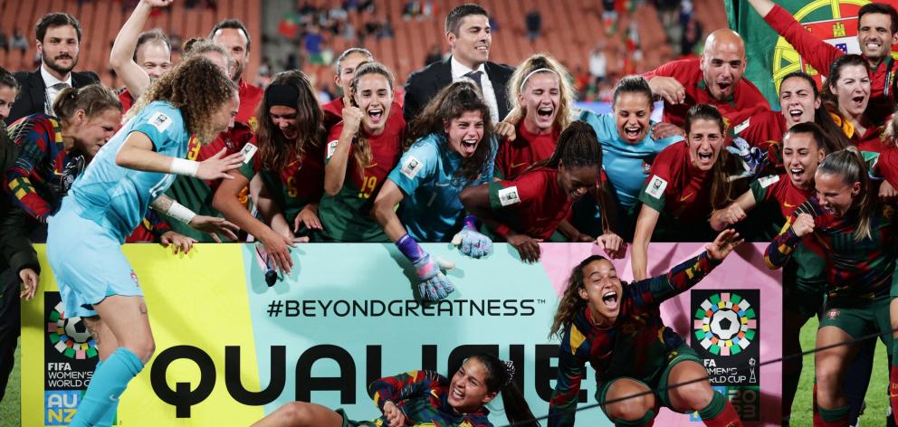 Portugal coach Francisco Neto celebrates with his players after the side qualified for the Women...