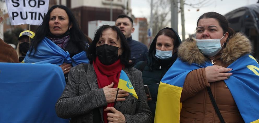 People take part in a new rally in front of the Russian embassy in Madrid after the attacks in...