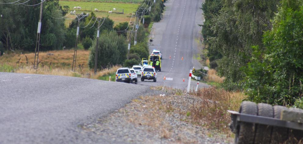 Emergency services work at the scene of a fatal tractor crash in Otapiri Stream, yesterday. PHOTO...