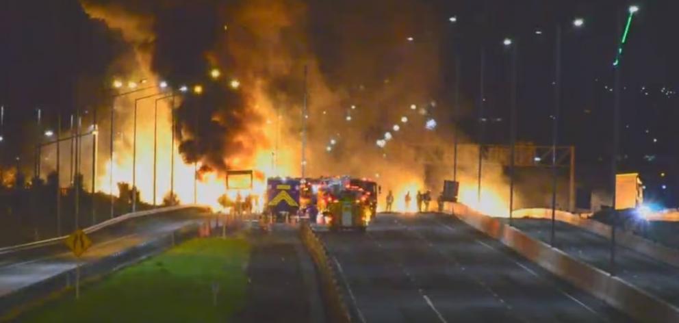 Firefighters at the scene of the massive truck fire on Auckland's Southern Motorway.