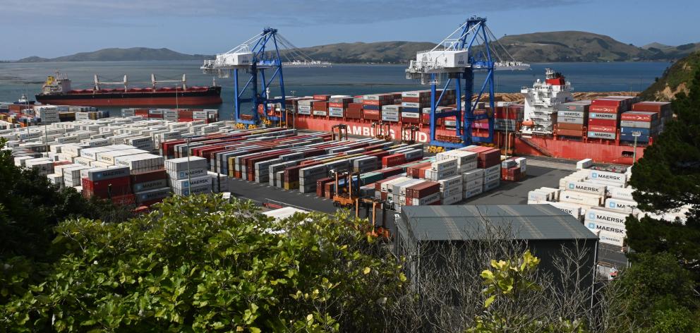 CP Nanjing (top left) approaches Port Chalmers as Rio Madeira is worked on yesterday. PHOTO:...