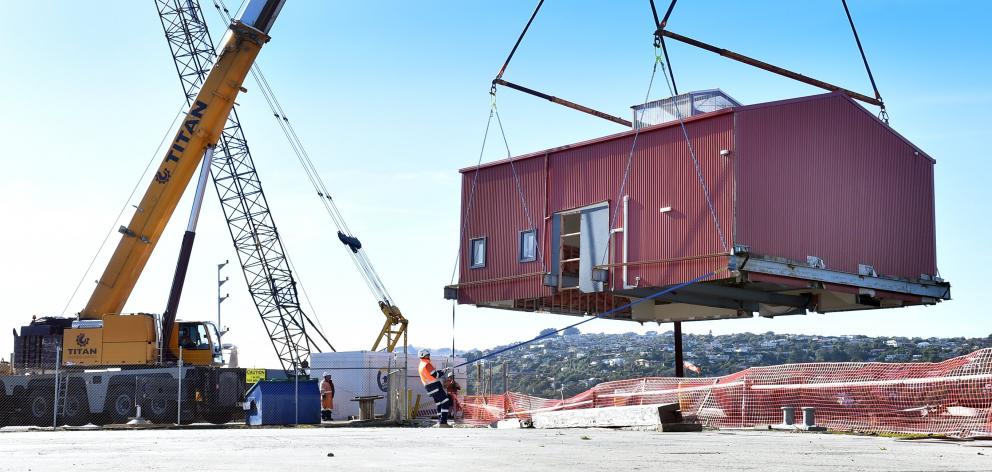 A large boat shed, built in 2014, is lifted into its new home at T/U wharf, to be used as the new...
