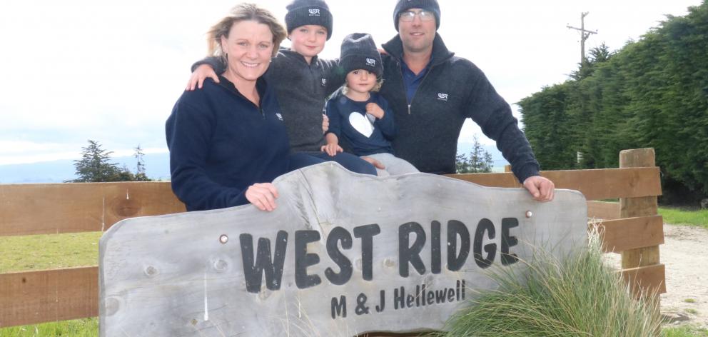 .Lawrence farmers Murray and Julie Hellewell are pictured in 2019 with son Riley (then 5) and...