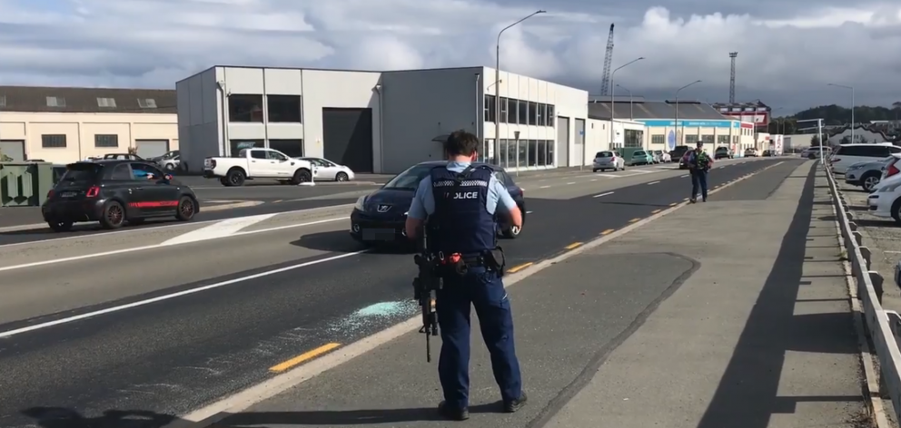 Shattered glass, which police cordoned off to inspect, on the kerb near the overbridge to Anzac...