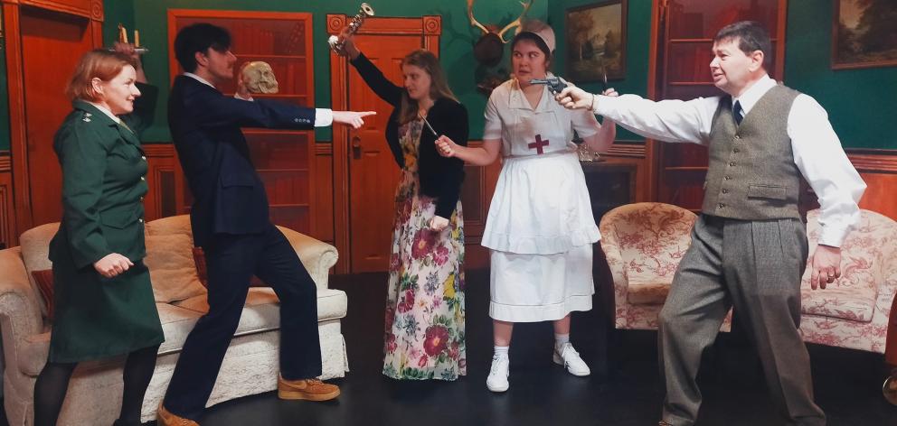 Waving a selection of weapons in a scene from the Taieri Dramatic Society’s production of Peter...