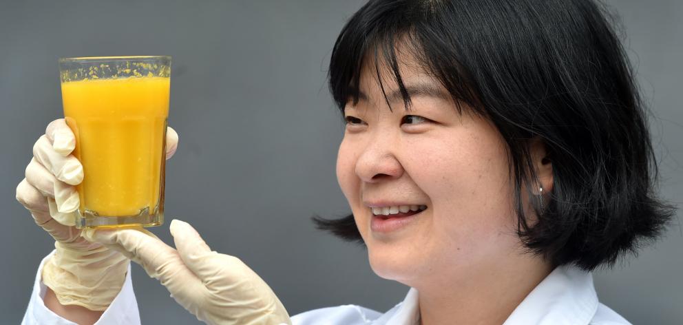 University of Otago food science researcher Dr Mei Peng holds a palatable glass of low-sugar...