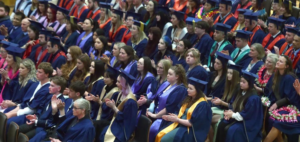 Graduates politely applaud. PHOTO: PETER McINTOSH