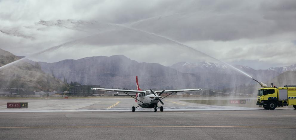 Welcome home: A water arch, courtesy of Queenstown Airport’s fire rescue team, greets Glenorchy...