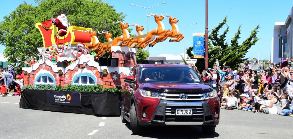 Santa Claus sits atop his sleigh with reindeer leading the way in Dee St, during the Invercargill...
