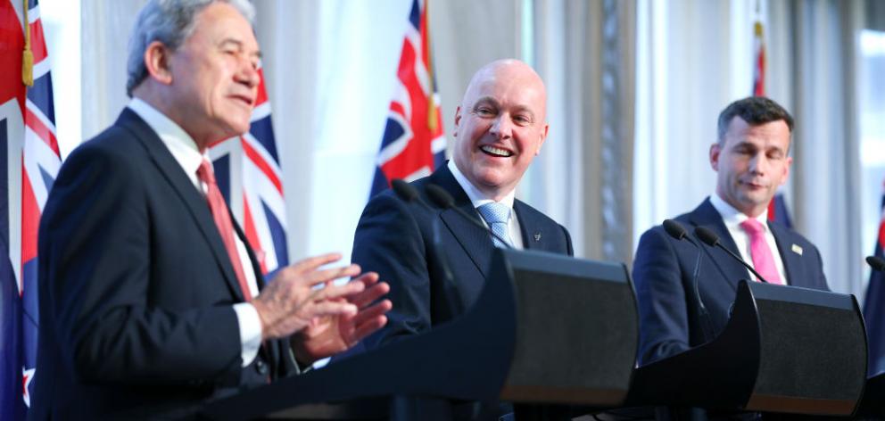 Prime Minister Christopher Luxon (centre) with deputy Winston Peters (right) and Act leader David...
