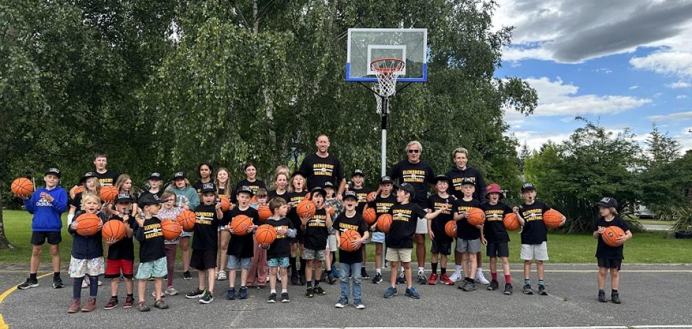 Glenorchy Primary School pupils, former NBL player Benjamin Knight and school staff with the...