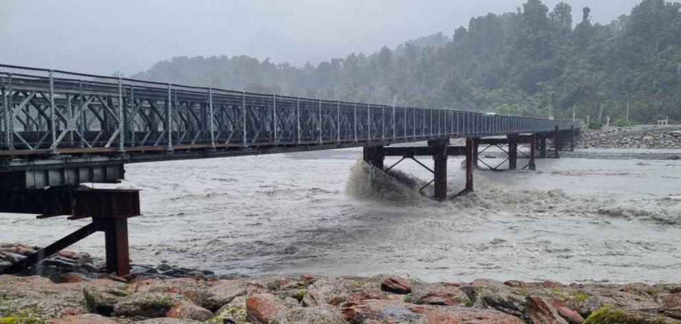 A raging torrent flows under the Waiho River bridge, south of Franz Josef, yesterday. PHOTO: RNZ