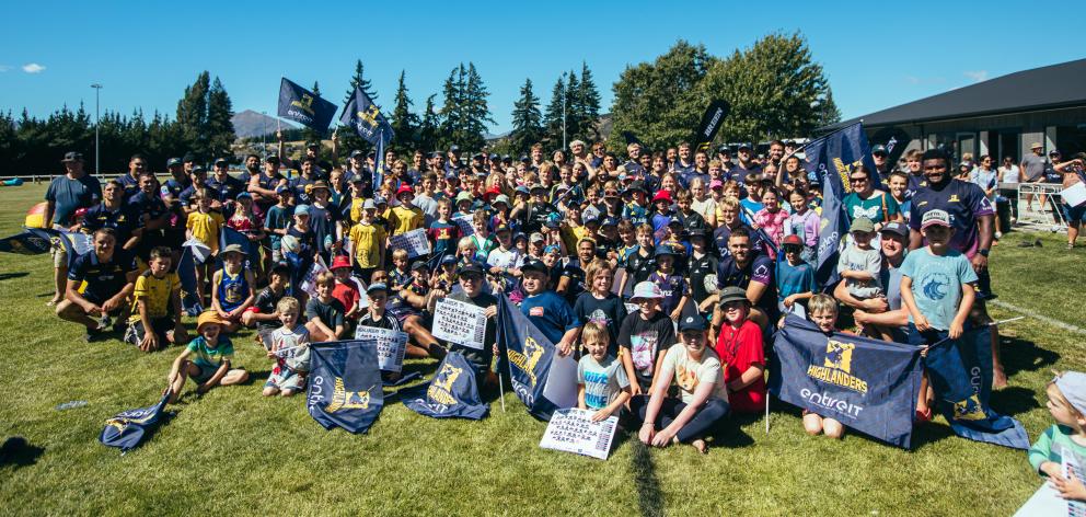 Young fans assemble for a group photo with their heroes. 