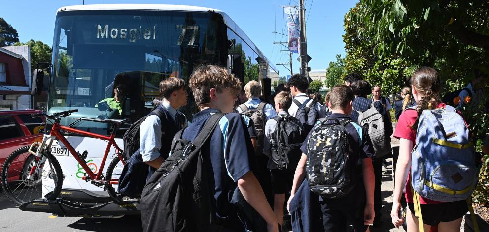 School pupils hustling to get a spot on the bus to Mosgiel in Green Island yesterday afternoon....