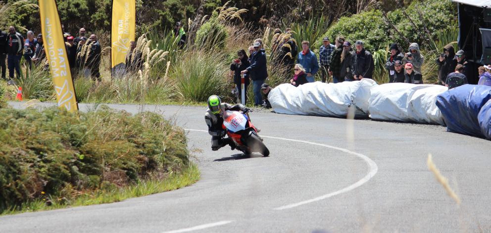 Spectators look on as a competitor races up Bluff Hill in the Burt Munro Challenge Bluff Hill...