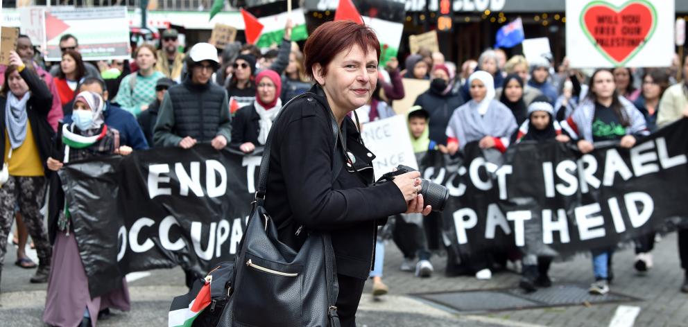 Dunedin public libraries digital outreach co-ordinator Jill Bowie takes a photo of the March for...