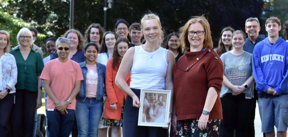 Holding a picture of her daughter Claire, Sally Aldrich, of Dunedin, joins Brain Health Research...