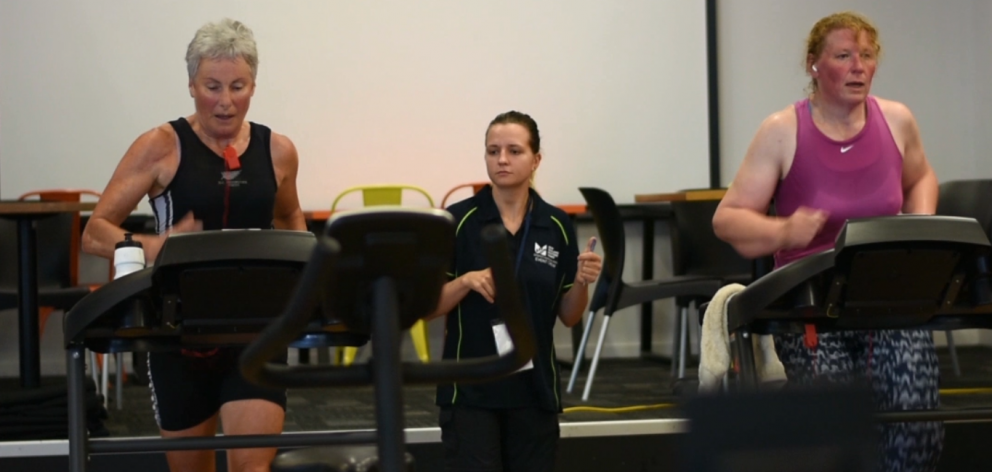 Indoor triathlete Jan Brosnahan (left) works up a sweat on the treadmill, alongside other Masters...