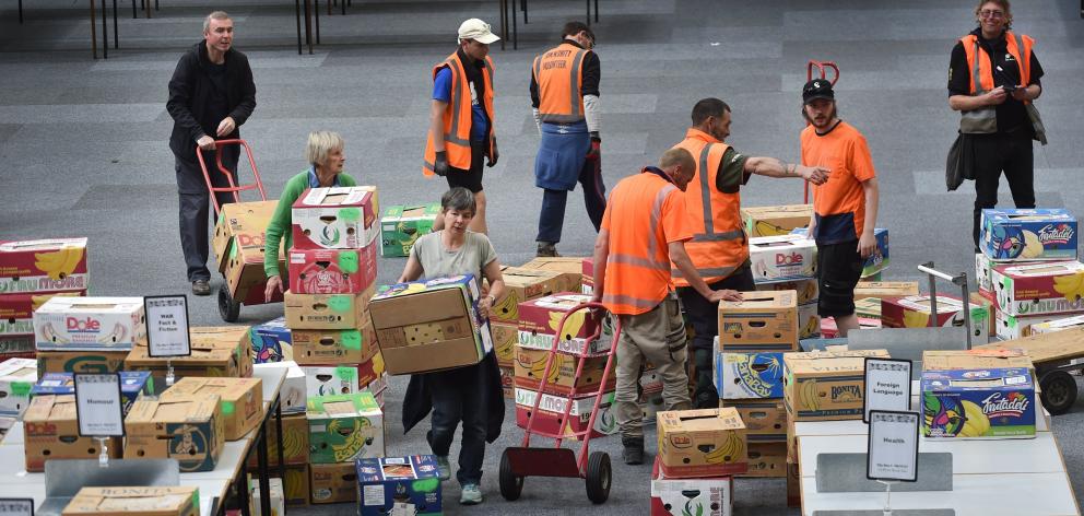 Volunteers sort boxes of books for the annual Regent Theatre 24 hour Book sale at the Edgar...
