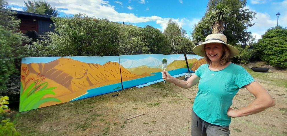 Wānaka mural artist Chrissy Wicks with a mural she is completing for Wānaka Plunket rooms. PHOTO:...