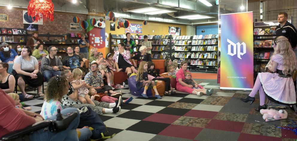 Families listen to children’s stories being read at Rainbow Story Time.
