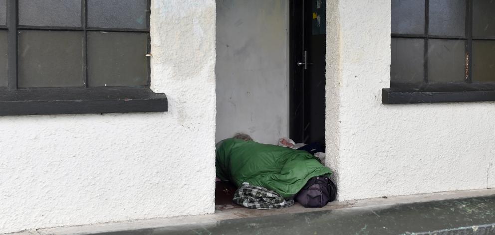 A homeless person asleep today in the porch of sports changing rooms at Kensington Oval, where...