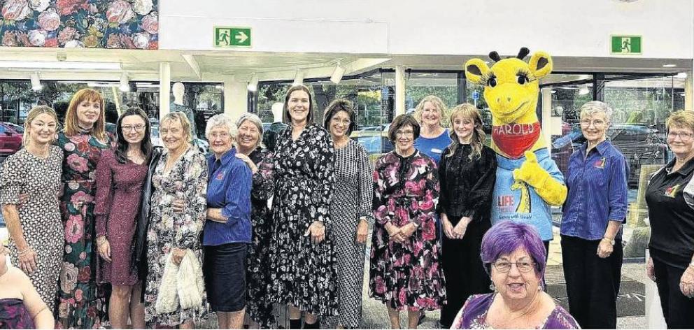 Harold the giraffe, Marion Dent (fifth from left) and Moyra Whiting (second from right) with...