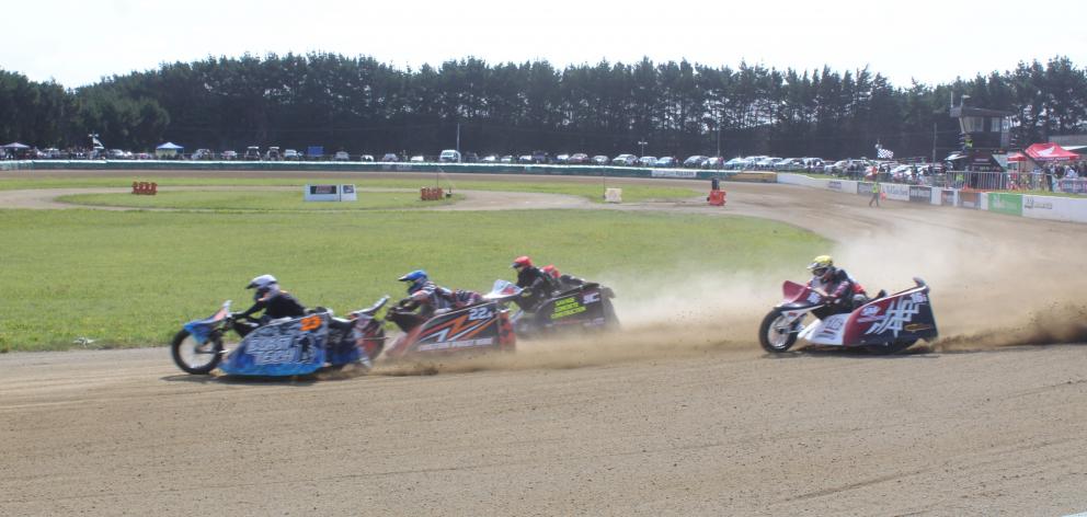 Sidecars make the dust fly at Oreti Park Speedway last Saturday.