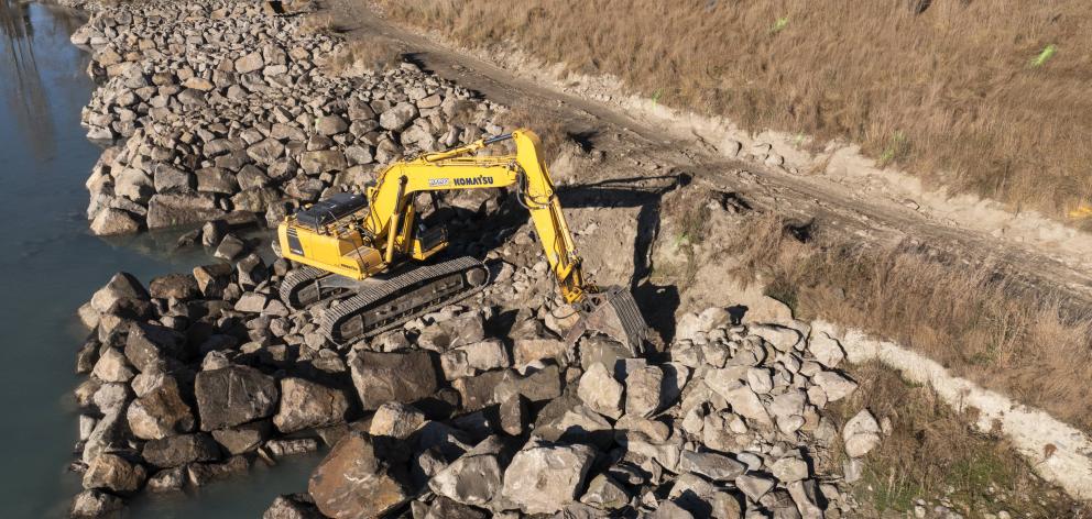 A digger works on flood protection measures along the Rangitata River. Photo: Supplied by...