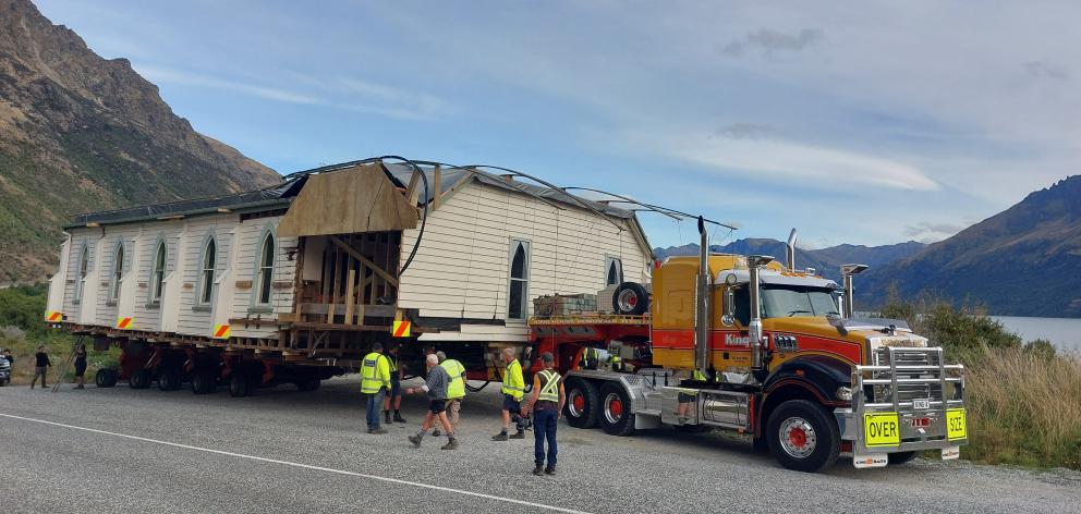 King House Removals staff wait on the side of the road near Queenstown to let traffic past late...