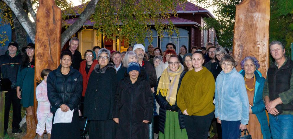 The Te Whare Koa Marae community gathers beside the newly installed pou on Saturday morning in...