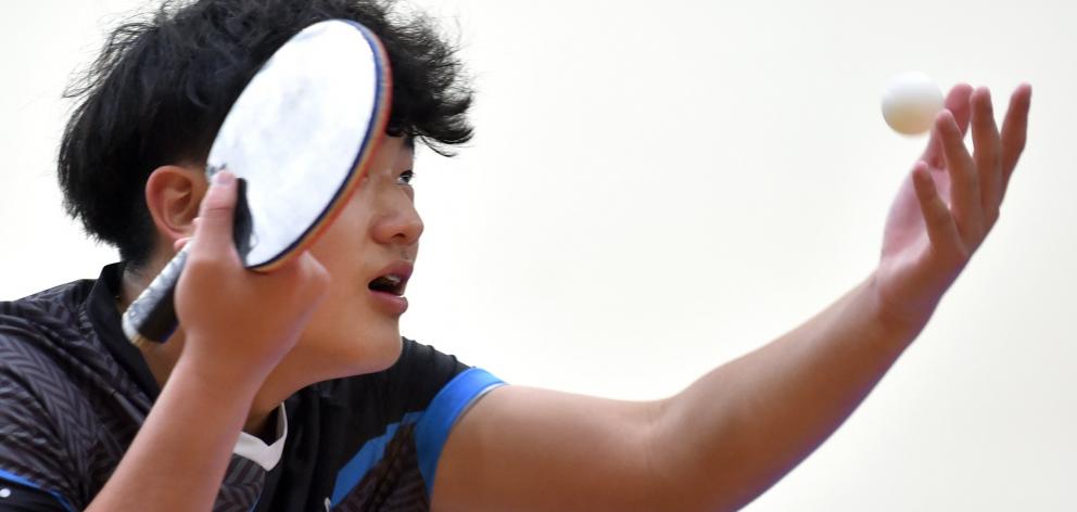 Auckland player Allen Zhu, 16, serves during a men’s singles match.